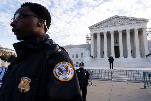 Supreme Court police officers stand outside as the court prepares to hear a case over whether former President Donald Trump is eligible to run for president in the 2024 election on Feb. 8, 2024. 