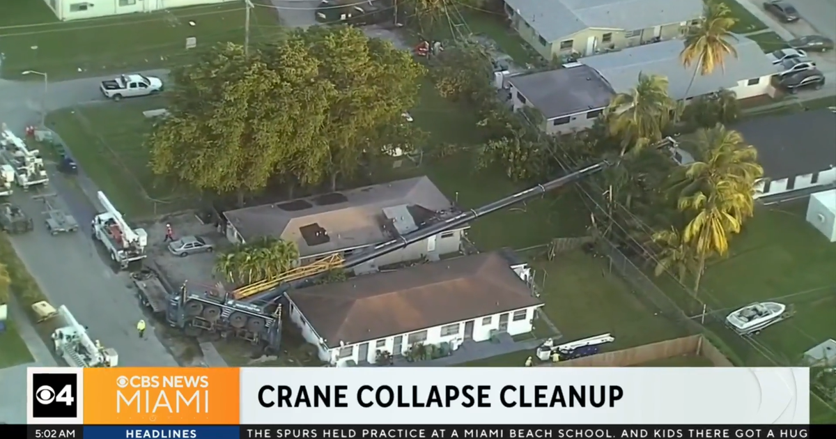 Overturned crane partially destroyed NE Dade condominium