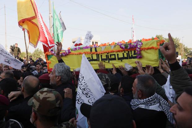 People carry a coffin of a commander from Kataib Hezbollah, who was killed in a U.S. drone strike, during a funeral in Baghdad, Iraq, Feb. 8, 2024. 