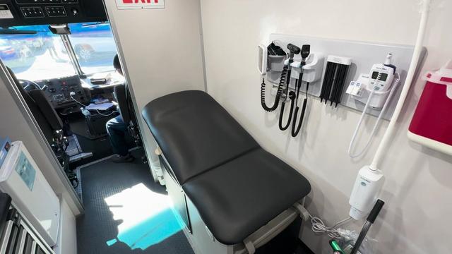 Medical equipment and a seating table inside a mobile medication unit. 