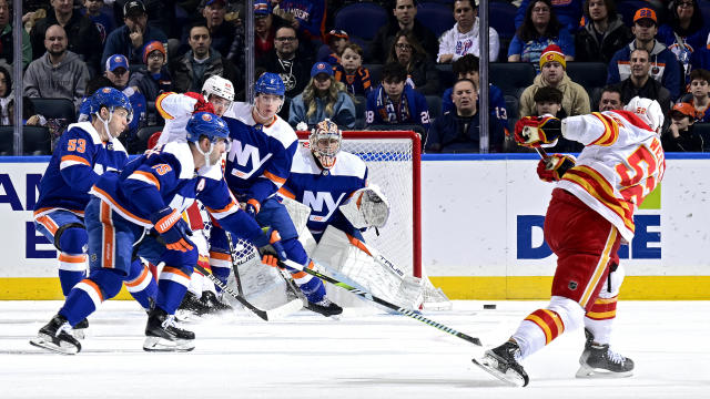 MacKenzie Weegar #52 of the Calgary Flames attempts a shot on Semyon Varlamov #40 of the New York Islanders during the first period at UBS Arena on February 10, 2024 in Elmont, New York. 