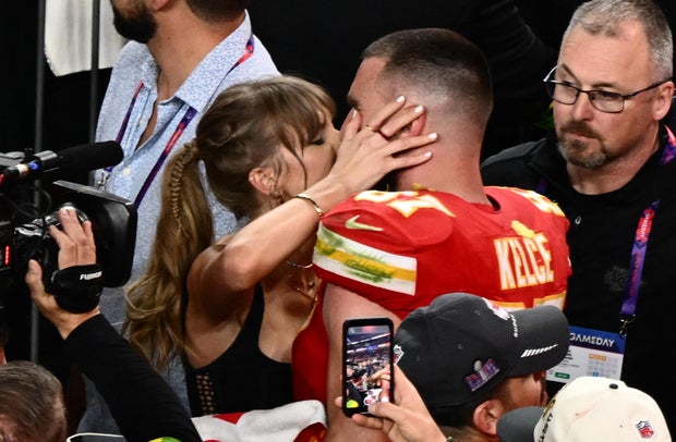 Taylor Swift kisses Travis Kelce #87 after the Kansas City Chiefs won Super Bowl LVIII