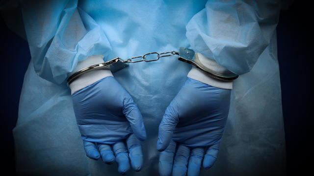 Doctor handcuffed, hands close-up, concept of medical corruption, bribery, crime 
