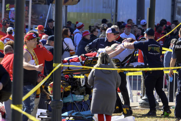 A woman is taken to an ambulance after a shooting following the Kansas City Chiefs' Super Bowl celebration in Kansas City, Missouri, Feb. 14, 2024. 