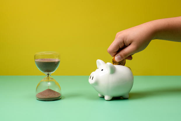 Piggy bank savings and hour glass 