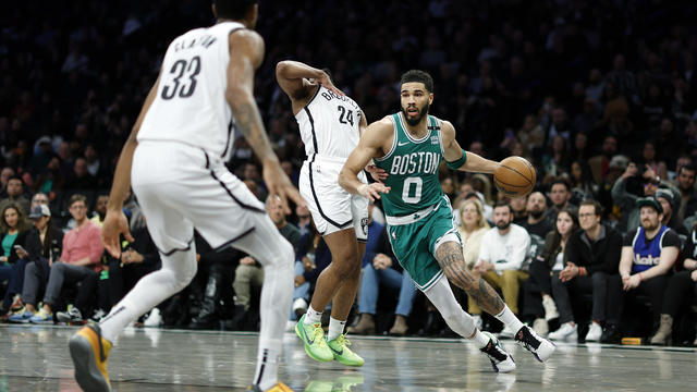 Jayson Tatum #0 of the Boston Celtics dribbles against Cam Thomas #24 and Nic Claxton #33 of the Brooklyn Nets during the second half at Barclays Center on February 13, 2024 in the Brooklyn borough of New York City. 