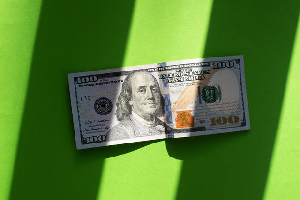 Dollars on a green background. Money. Currency. Inflation. World crisis. Pattern of dollar bills. 100 dollars. Financial minimalism. Exchange market. Money background. 