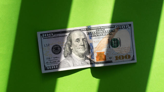 Dollars on a green background. Money. Currency. Inflation. World crisis. Pattern of dollar bills. 100 dollars. Financial minimalism. Exchange market. Money background. 
