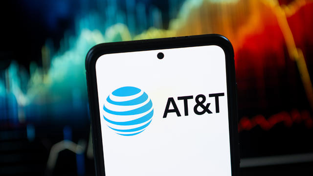 In this photo illustration a AT&T logo seen displayed on a 