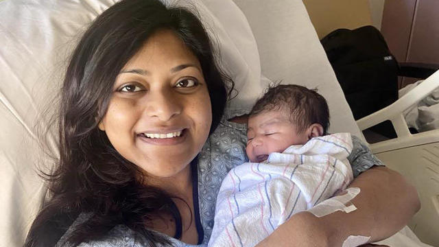 Sungida Rashid holding her newborn daughter in her arms 