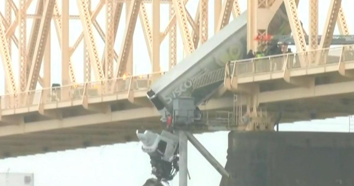 Driver rescued after wreck leaves big-rig dangling off Louisville bridge
