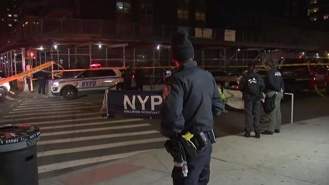 NYPD officers and collision investigators stand in a blocked off East Village street. 