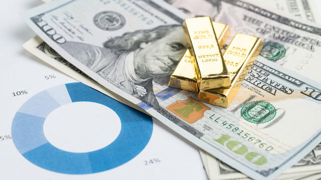 Wealth management or investment asset allocation concept, gold bars / ingot on pile of US dollar banknotes on percentage pile chart using in balance risk and rich in financial investment idea 