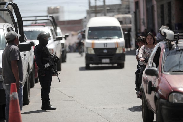 Police officers guard the scene where mayoral candidate Armando Perez Luna was killed, in Maravatio