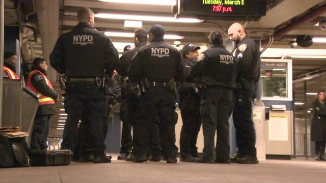 A group of NYPD officers inside a New York City subway station. 