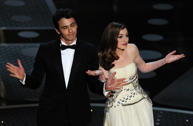 James Franco and Anne Hathaway introduce veteran actor Kirk Douglas onstage at the Academy Awards at the Kodak Theatre on Feb. 27, 2011, in Hollywood, California.