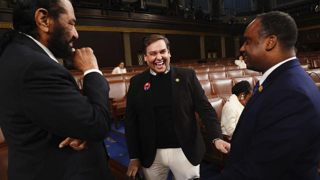 Former Rep. George Santos, R-N.Y., center, talks with Rep. Al Green, D-Texas, left,and Rep. Joe Neguse, D-Colo., before President Joe Biden delivers the State of the Union address to a joint session of Congress at the Capitol, Thursday, March 7, 2024, in Washington. 