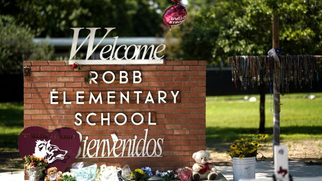 Flowers and toys are placed outside the former Robb Elementary School in Uvalde, Texas, May 24, 2023. 