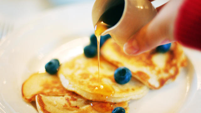 Pouring Maple Syrup Over Pancakes 