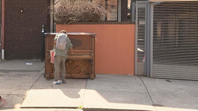 A man stops to play the piano that sits at 12th and Lombard Streets in Philadelphia. 
