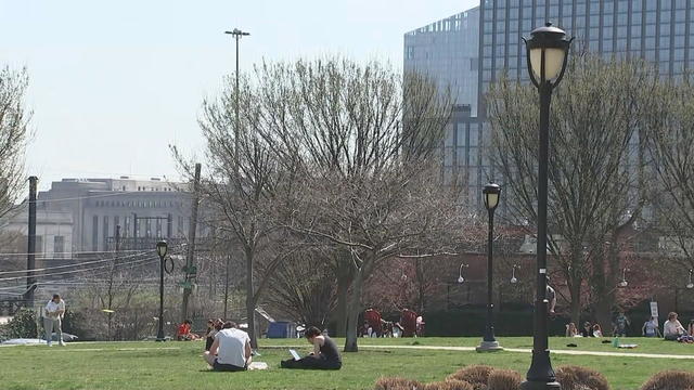 People spend time outdoors in Philadelphia on a warm March day. 