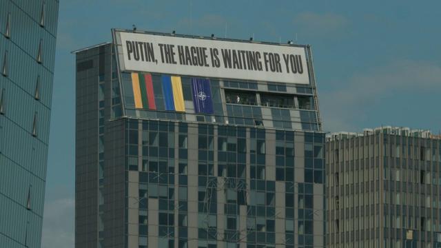 A sign reading: Putin, the Hague is waiting for you 