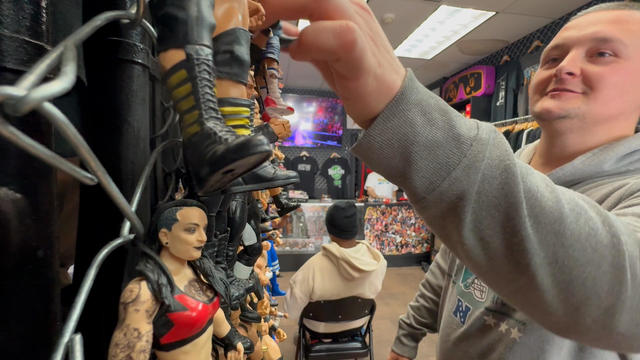 A shopper reaches for a wrestling action figure at Suplex Vintage in Philadelphia 