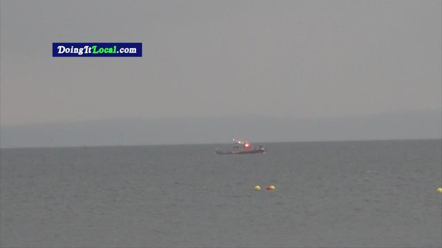 A boat searches the waters in the Long Island Sound. 