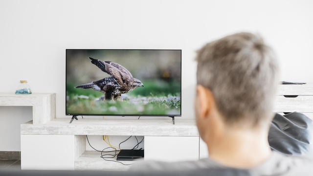 Man watching television in living room 