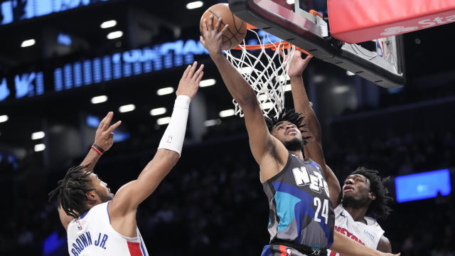 Brooklyn Nets guard Cam Thomas (24) goes to the basket against Detroit Pistons center James Wiseman (13) and forward Troy Brown Jr. (7) during the first half of an NBA basketball game, Saturday, April 6, 2024, in New York. 