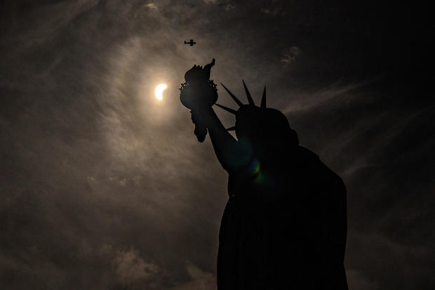 Statue of Liberty is seen during a partial solar eclipse 