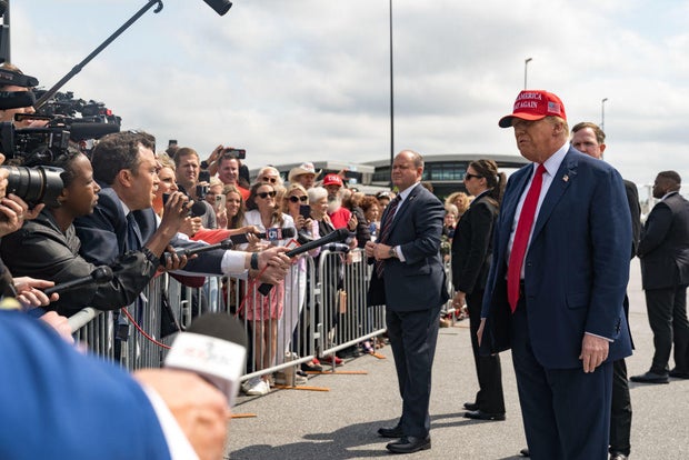 Former President Donald Trump speaks to the media as he arrives at the Atlanta Airport on April 10, 2024.