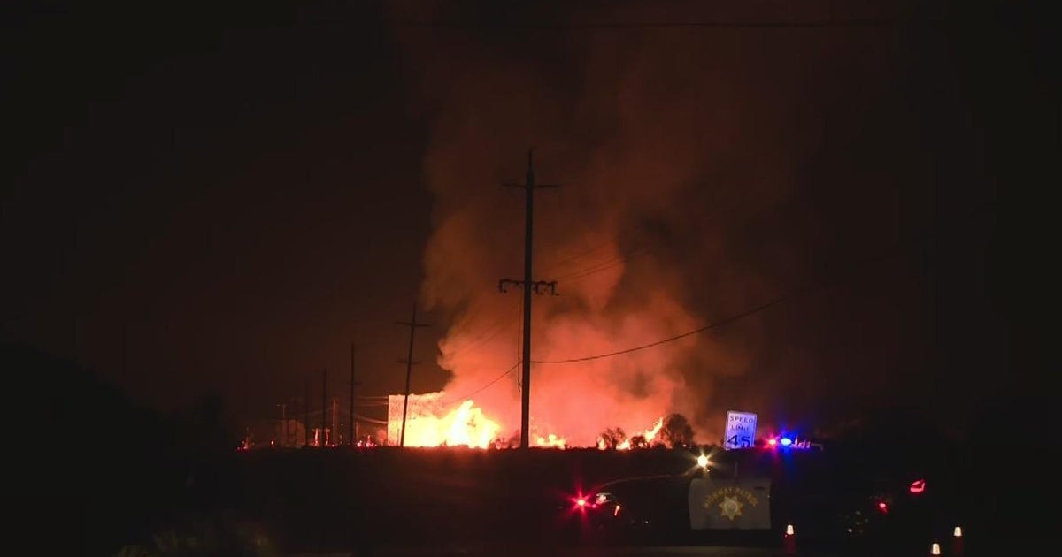 Massive fire burns at wood pallet facility near Tracy