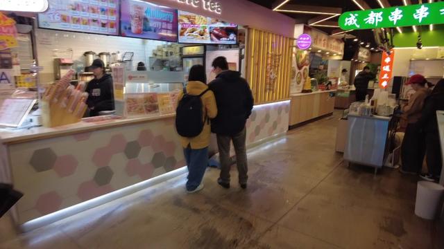 A food court full of Asian food booths and kiosks. 