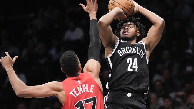 Brooklyn Nets guard Cam Thomas (24) shoots against Toronto Raptors forward Garrett Temple (17) during the first half of an NBA basketball game Wednesday, April 10, 2024, in New York. 