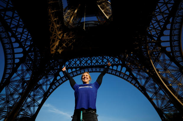 Athlete Anouk Garnier celebrates the world record for rope climbing on the Eiffel Tower in Paris 