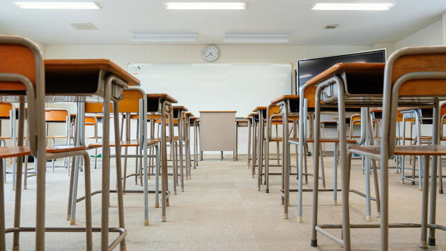 Empty classroom with rows of desks at a community college 