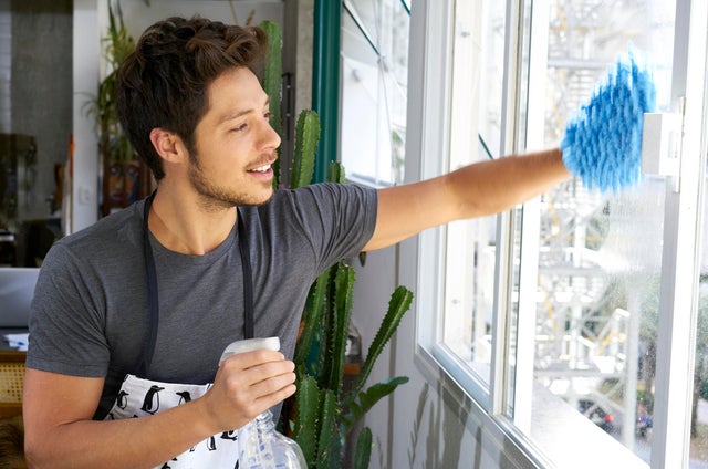 Man cleaning window panes 