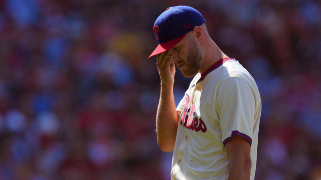 Zack Wheeler of the Philadelphia Phillies puts a hand to his face as he makes his way to the dugout after being removed from the game in the top of the sixth inning against the Pittsburgh Pirates at Citizens Bank Park 