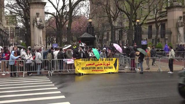 Pro-Palestinian demonstrators gather outside the main entrance to Columbia University. 