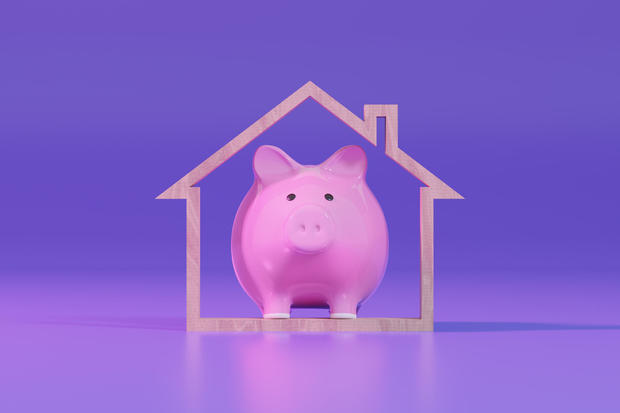 Piggy Bank and Wooden House Shape. Mortgage Loan and Home Ownership. 