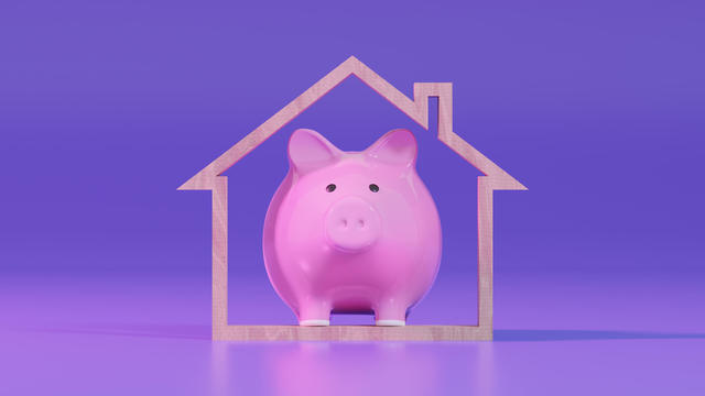 Piggy Bank and Wooden House Shape. Mortgage Loan and Home Ownership. 