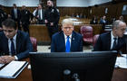 Former President Donald Trump sits with his legal team 