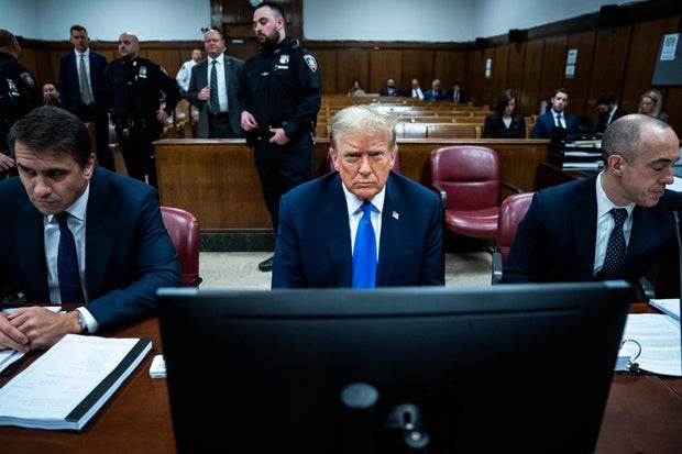 Former President Donald Trump sits with his legal team