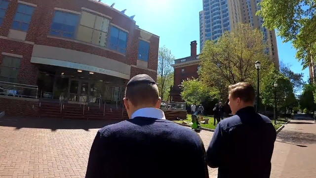 A Jewish student talks to a reporter as he walks toward a building on the University of Pennsylvania campus 