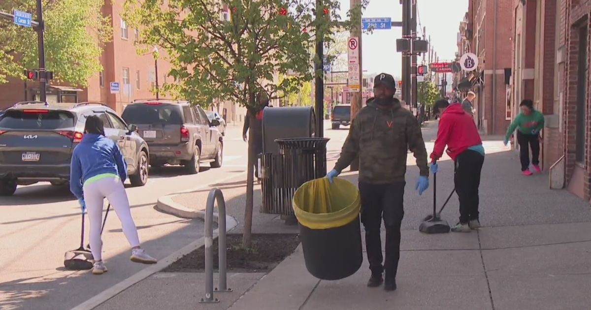 South Side business owners participate in street cleaning initiative for Earth Day.