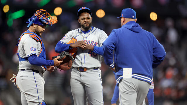 Catcher Omar Narváez #2 and pitching coach Jeremy Hefner #65 come out to speak to Luis Severino #40 of the New York Mets in the fifth inning of their game against the San Francisco Giants at Oracle Park on April 23, 2024 in San Francisco, California. 