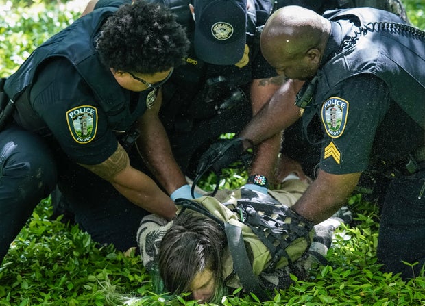 Police officers detain a demonstrator during a protest against the war in Gaza at Emory University on April 25, 2024, in Atlanta, Georgia. 