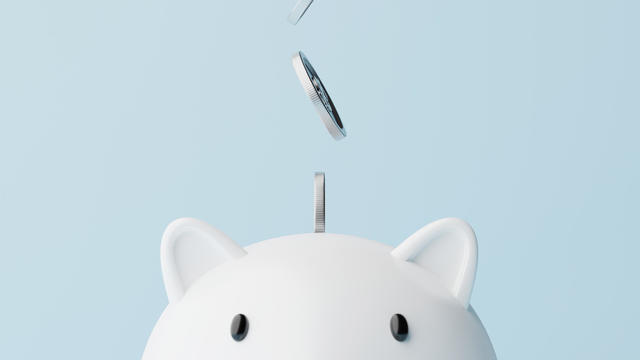 Save money and investment concept. Closeup piggy bank and silver coins falling. 3d rendering illustration 