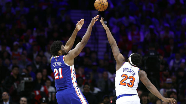 Joel Embiid #21 of the Philadelphia 76ers shoots over Mitchell Robinson #23 of the New York Knicks during the second quarter during game three of the Eastern Conference First Round Playoffs at the Wells Fargo Center on April 25, 2024 in Philadelphia, Penn 